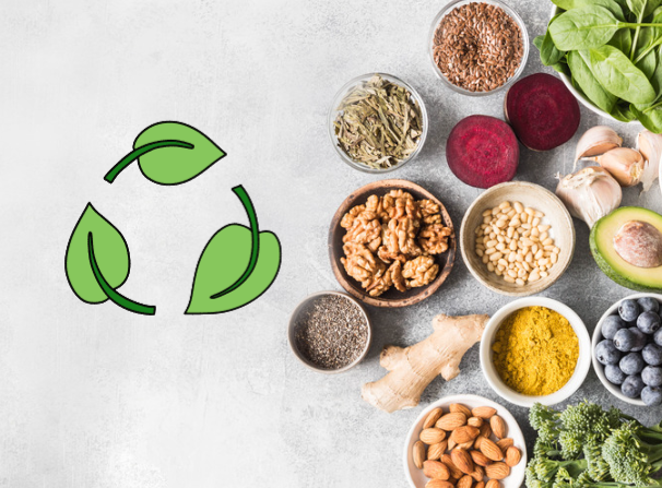 A table top with food in bowls, with a sustainability logo made of three illustrated green leaves.