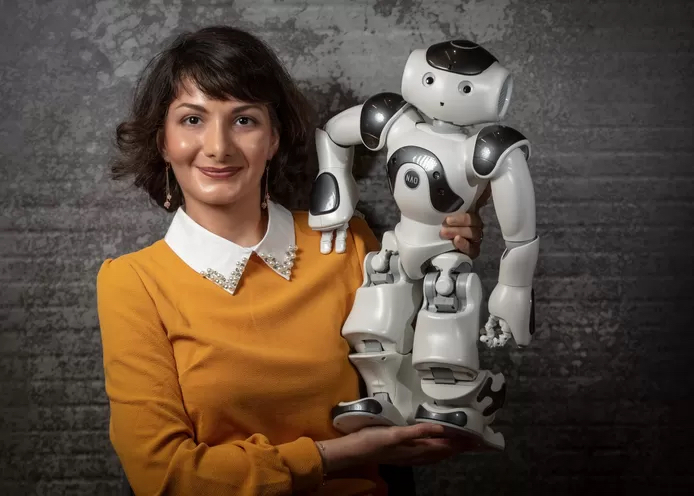 Woman holding robot