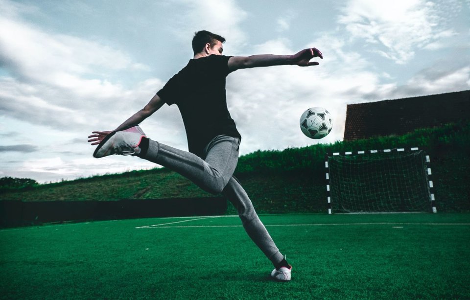 Football players about to kick the ball