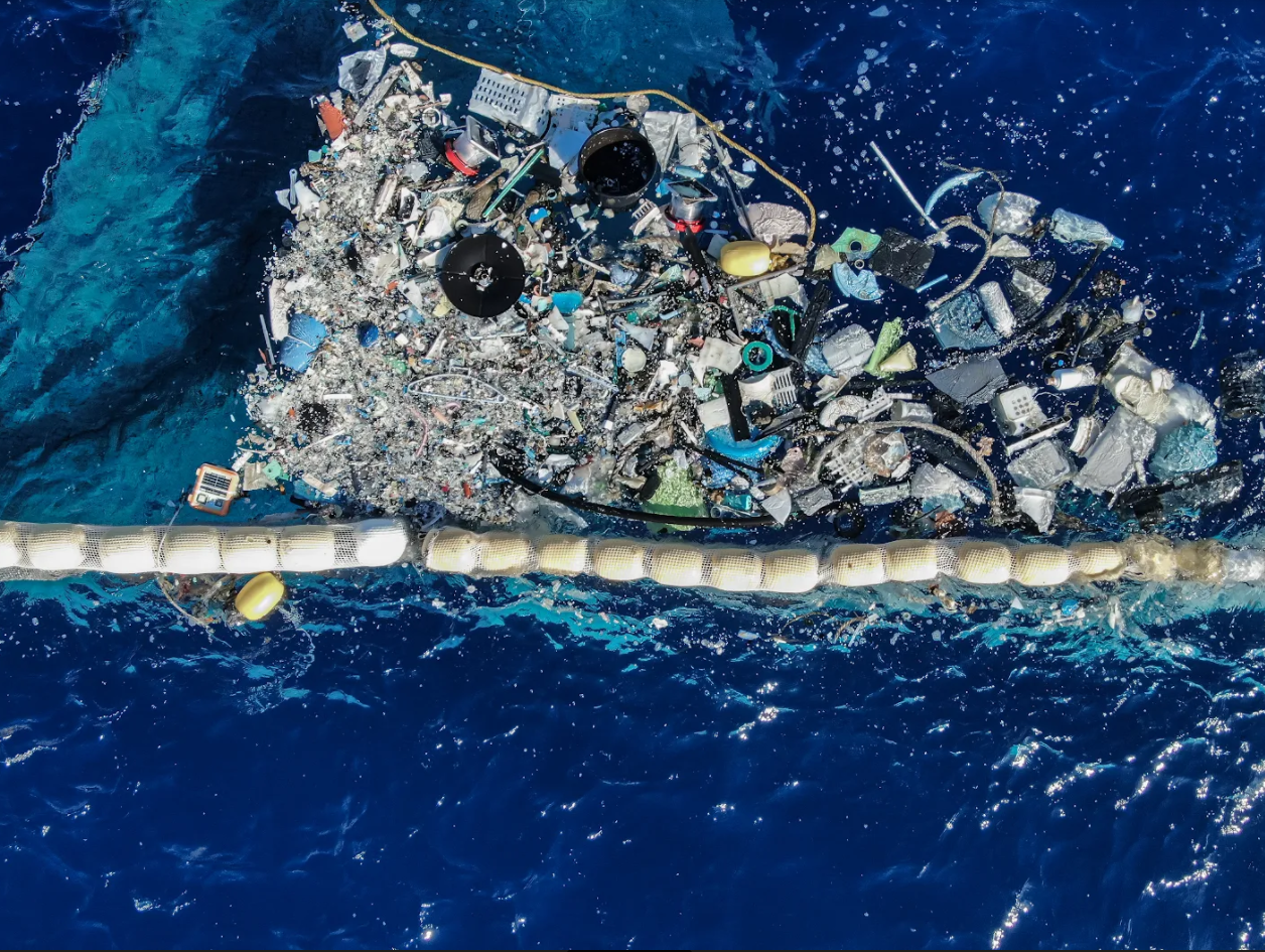 Evolving Methodologies, photo of sea with rubbish floating on the surface of the water.